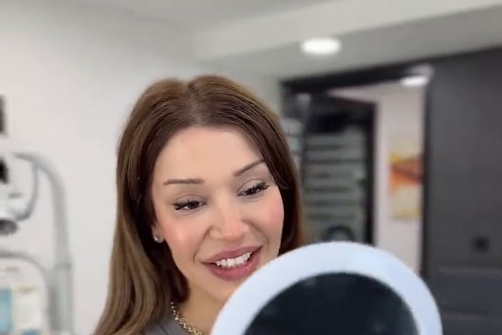 A patient checking her result in the mirror